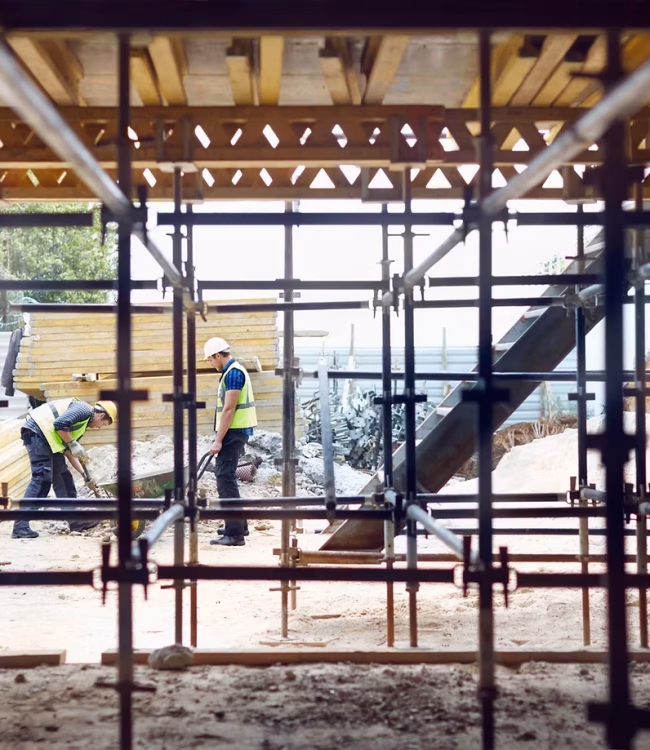 Two guys working on a construction site.